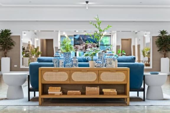 a living room with a blue couch and a wooden table