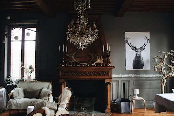 A living room with a fireplace and a chandelier.