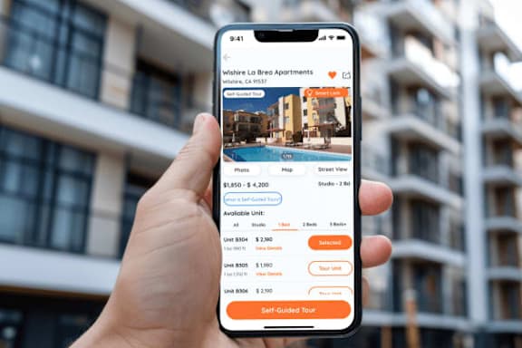 A person is holding a phone displaying a self-guided tour option for Wishere Lo Loeo Apartments.
