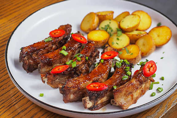 Plate of food with meat and potatoes.