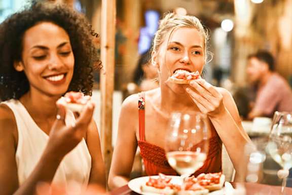 Two women enjoying a meal together at a restaurant.