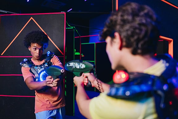 Two people playing a video game with Nintendo Wii controllers.