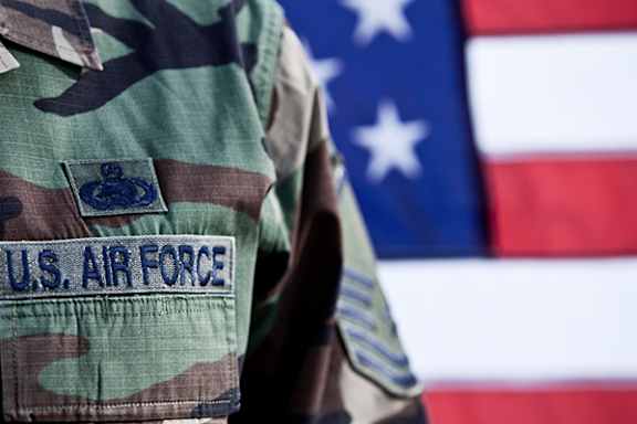 A U.S. Air Force patch is pinned to a camouflage uniform.