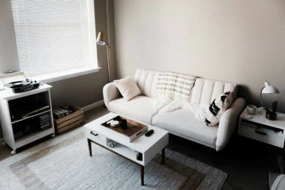 a living room with a white couch and a coffee table