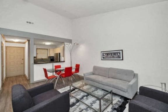 a living room with a couch and a table with chairs