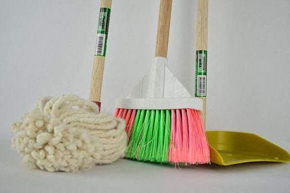 two brooms and a mop and a scoop of wool