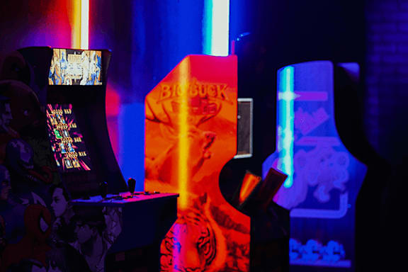 A gaming arcade setup with a Bioshock game on the screen.