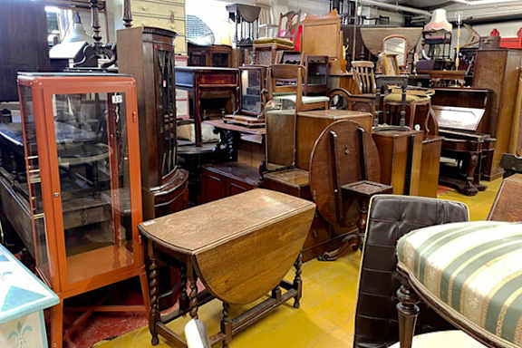 A collection of antique furniture is on display.