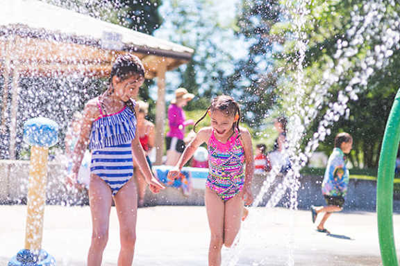 Two children playing in a water park.