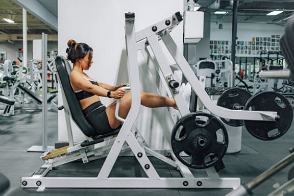 a woman sitting on a gym machine