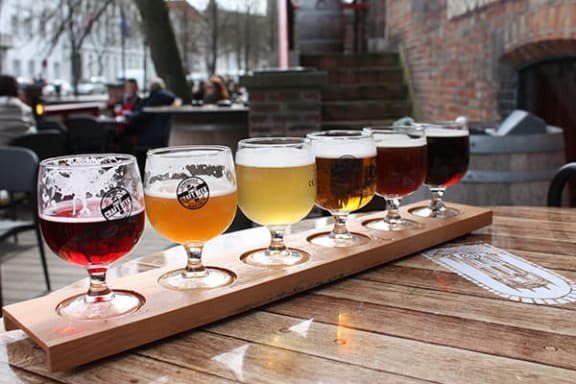 a tray of different beers on a table