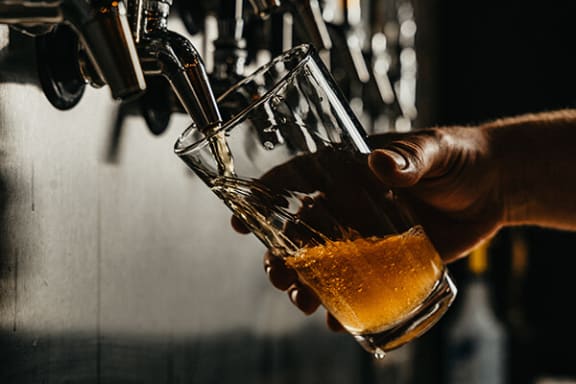 a pint of beer being poured into a glass