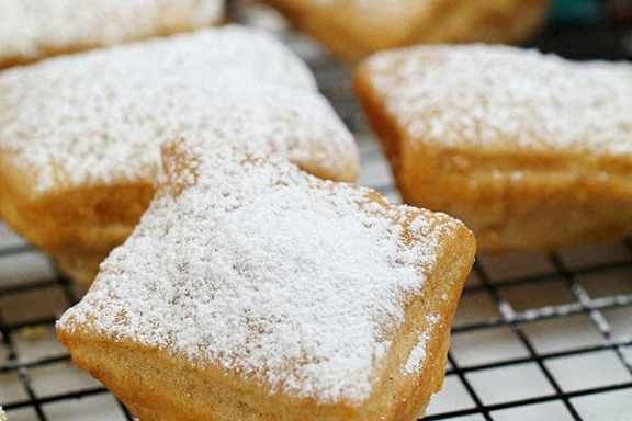 A close up of a pastry with powdered sugar on top.