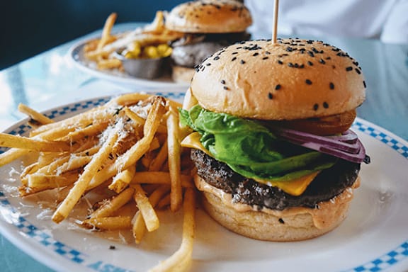 A burger and fries on a plate.