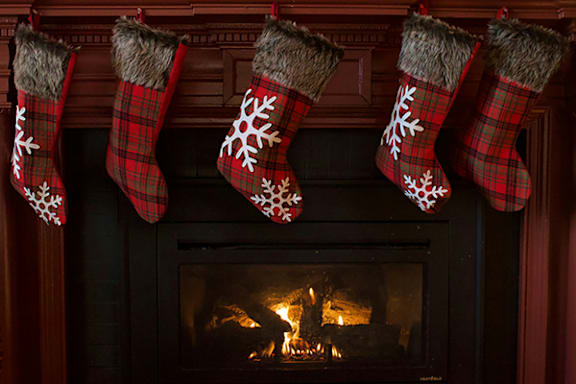 a fireplace with christmas stockings hanging on it