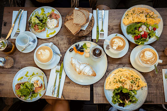 A table full of food and drinks.
