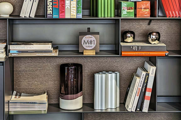 a shelf with books and other items on it