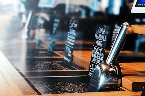 A coffee shop with a coffee grinder in the foreground.