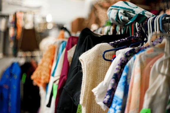 Clothes hanging on a rack in a store.