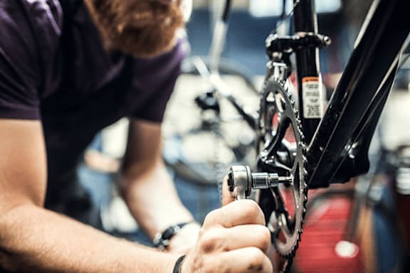 A man is repairing a bicycle.