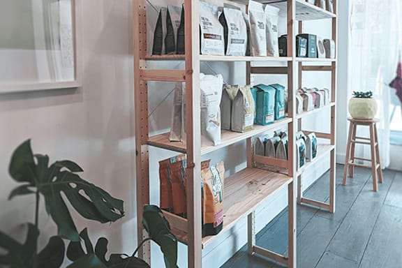 A wooden shelf with various items on it.