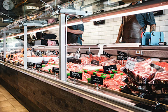 A butcher shop with a variety of meats on display.