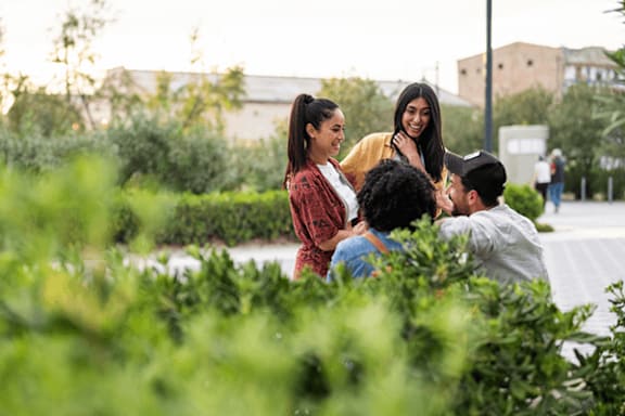 A group of people are sitting in a garden.