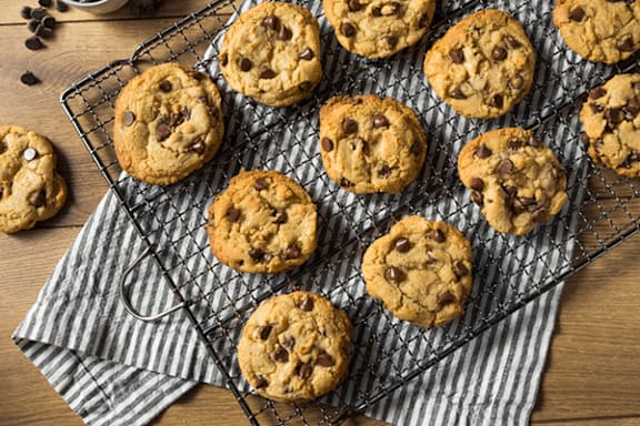 Chocolate chip cookies on a wire rack.