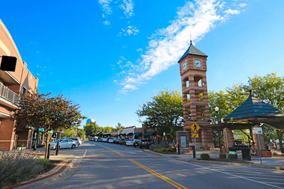 A street with a clock tower in the background.