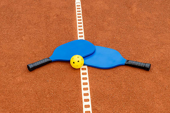 tennis racket and ball on a tennis court