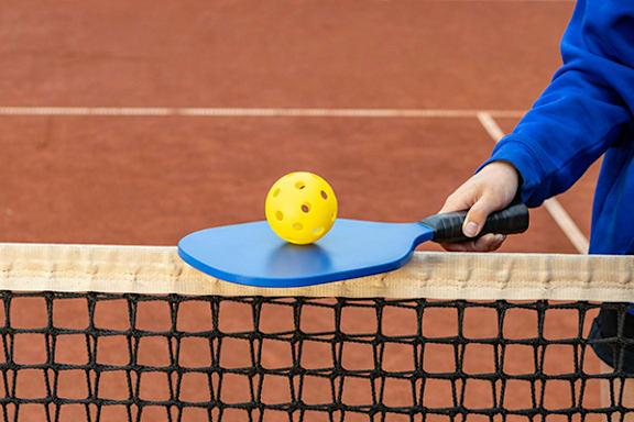 a tennis player hitting a ball with a racket