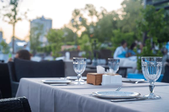 A table set for a meal with a view of the city in the background.