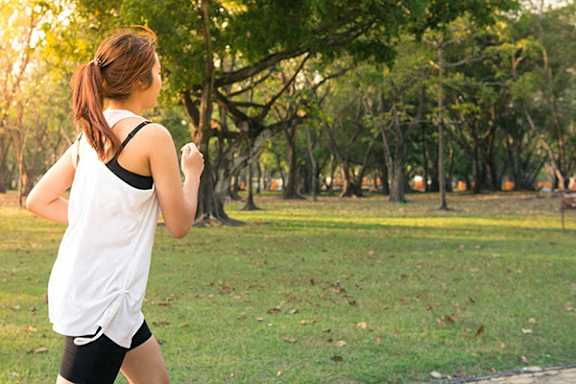 a woman running in the park
