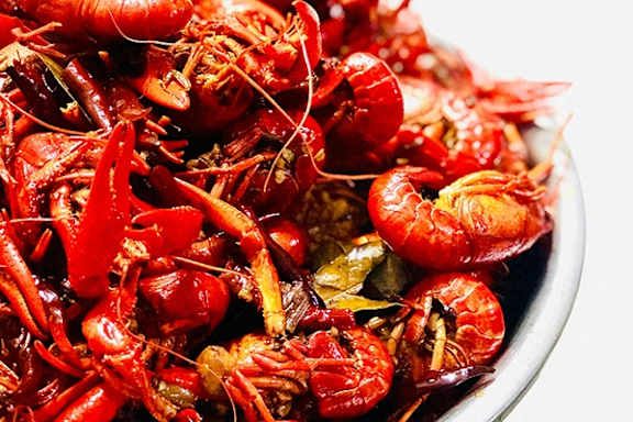 A bowl full of cooked crawfish.