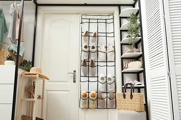A shoe rack with multiple pairs of shoes hanging on it.