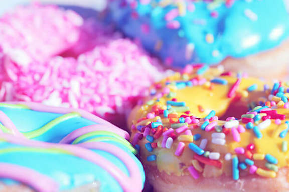 A close up of a donut with sprinkles.