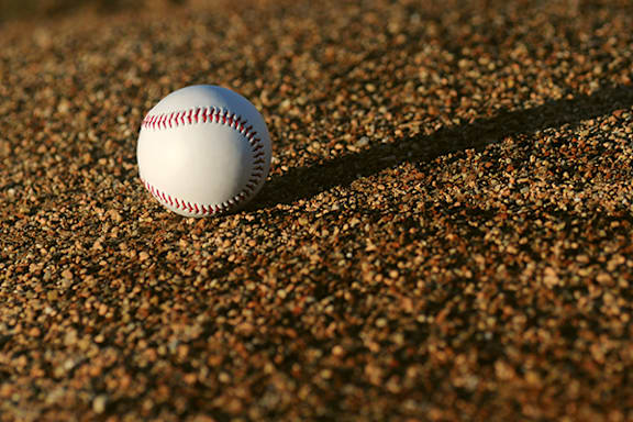 a baseball ball sitting on the ground