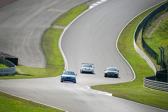 a group of cars driving on a race track