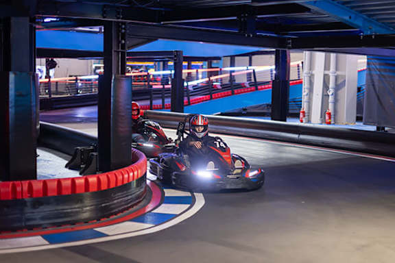 Two go kart racers on a track.