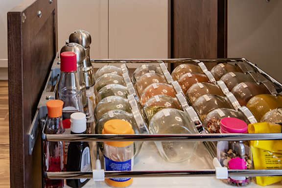 A spice rack with many different spices and condiments.