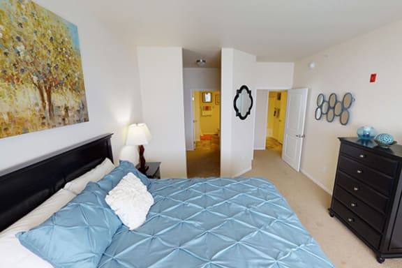 a bedroom with a large bed and a dresser
