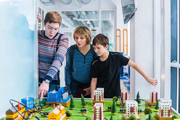 Three people playing a board game.