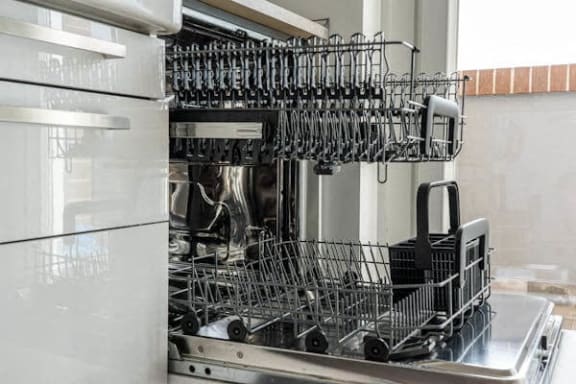 a dishwasher filled with wine glasses in a kitchen