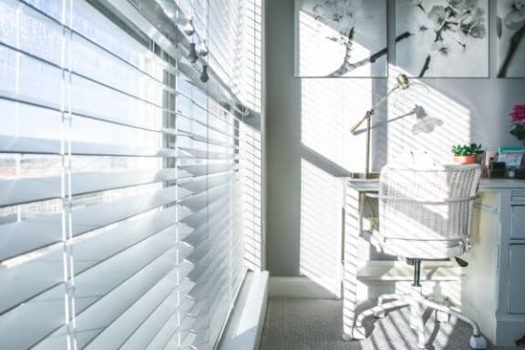 a white chair sitting in a room next to a window