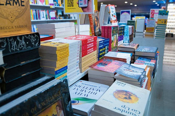 a pile of books on display in a bookstore