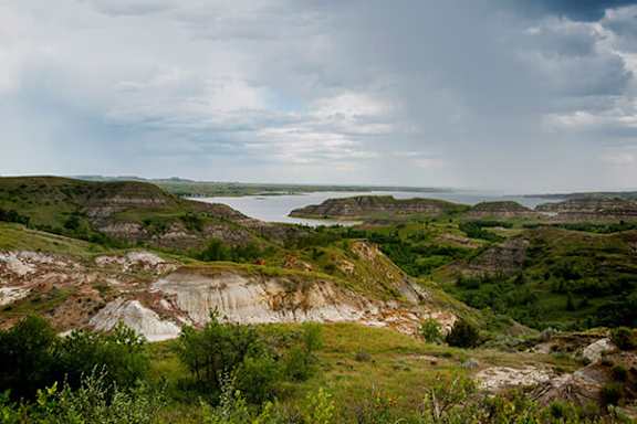 A landscape with a body of water surrounded by rocky hills.