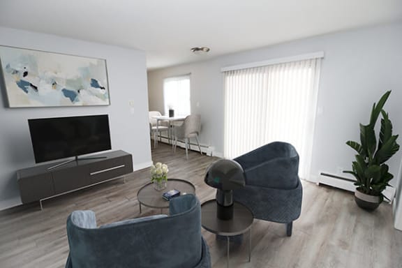 a living room filled with furniture and a flat screen tv