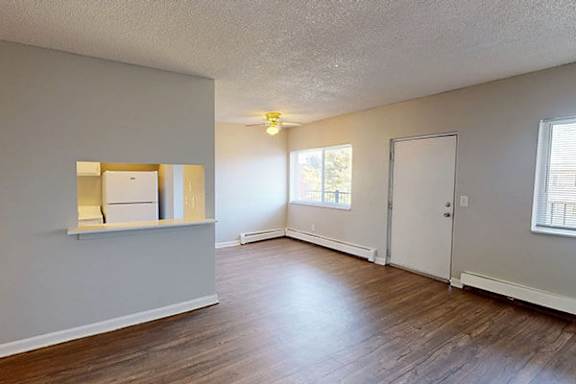 A room with wooden floors and white walls.