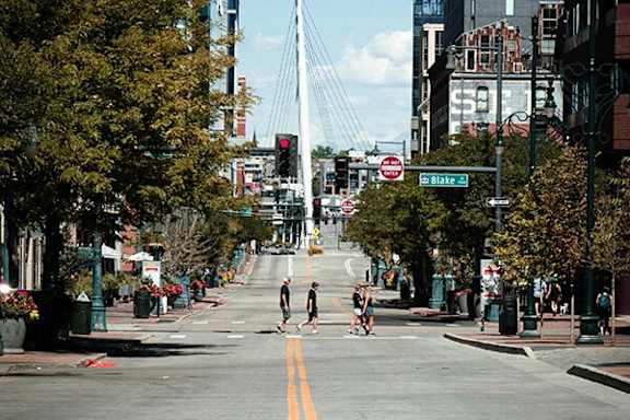 A street view with a pedestrian crossing the road.