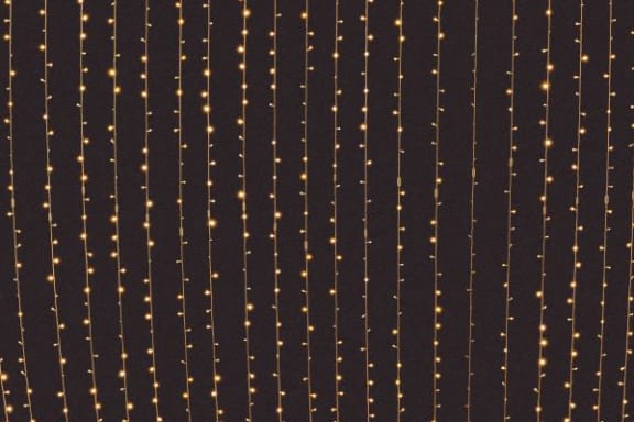 a row of strings of lights on a black background